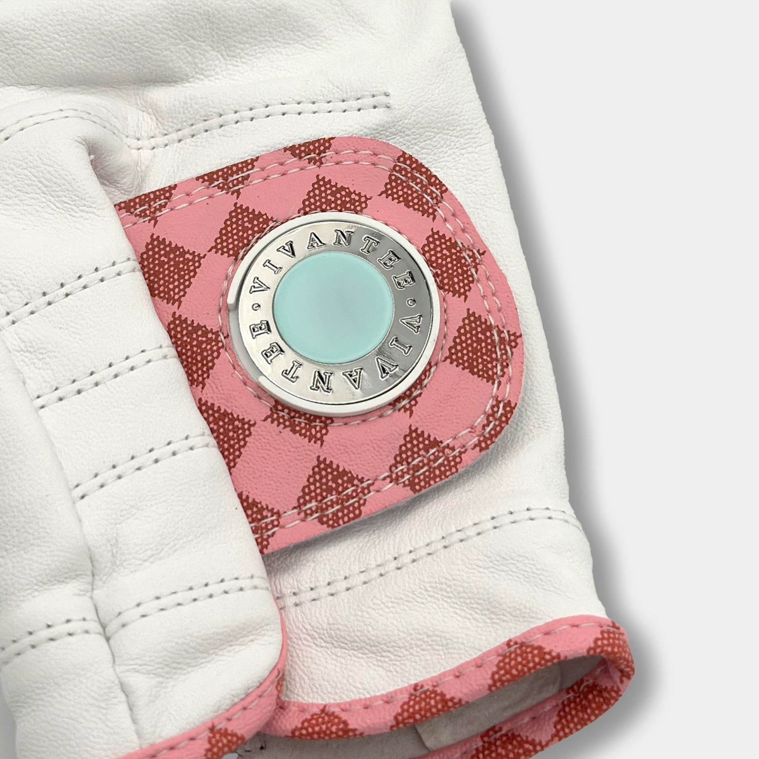 Close up of women's pink checkered golf glove with tiffany blue ball marker by VivanTee Golf.