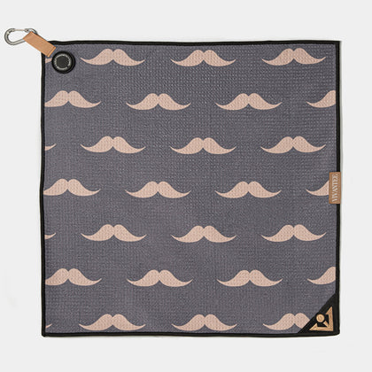 Gray magnetic golf towel with beige mustache pattern and a leather strap on a white background