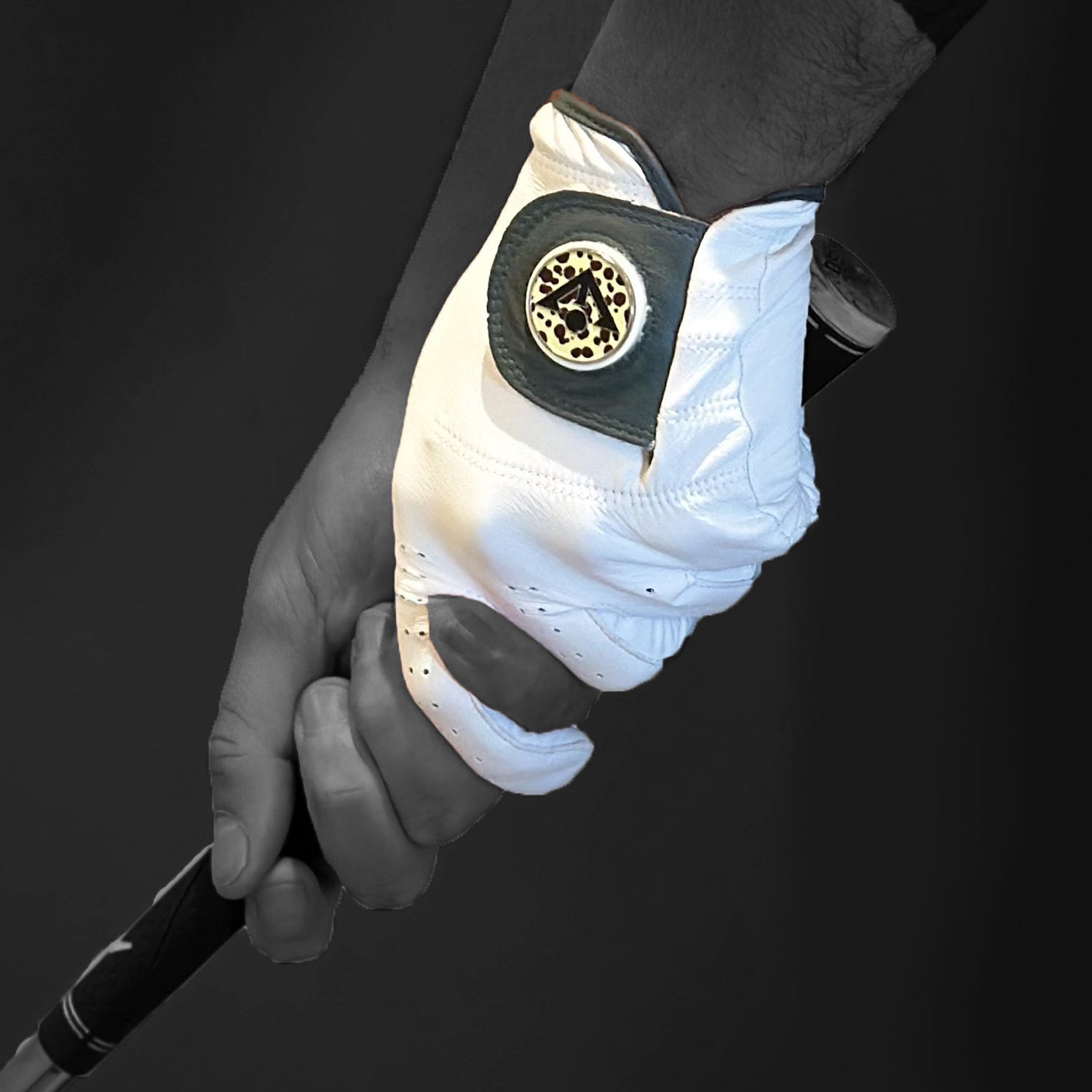 women's colored golf glove with a cheetah print ball marker across a black and white background.